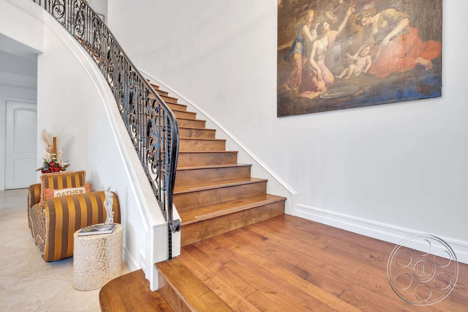 Medit 172 - textured accent wall, curved staircase, wrought iron railings, white painted walls, natural light entry, marble entryway flooring, open space foyer, hardwood staircase, classic decorative painting