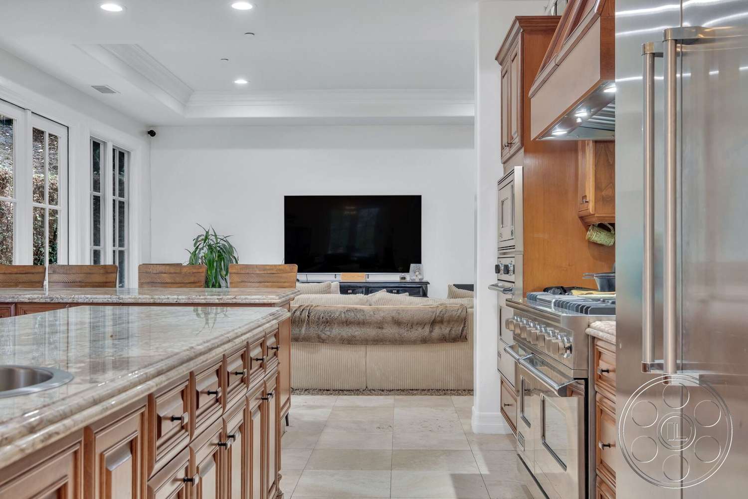 Medit 172 - ceramic tile flooring, floor-to-ceiling windows, green plant decor, open-concept living space, comfortable sectional sofa, flat-screen television, stainless steel refrigerator, recessed ceiling lights, wooden kitchen cabinets, stainless steel gas range, white painted walls, modern living room, granite kitchen island countertop, elegant kitchen design, dining area with bar stools
