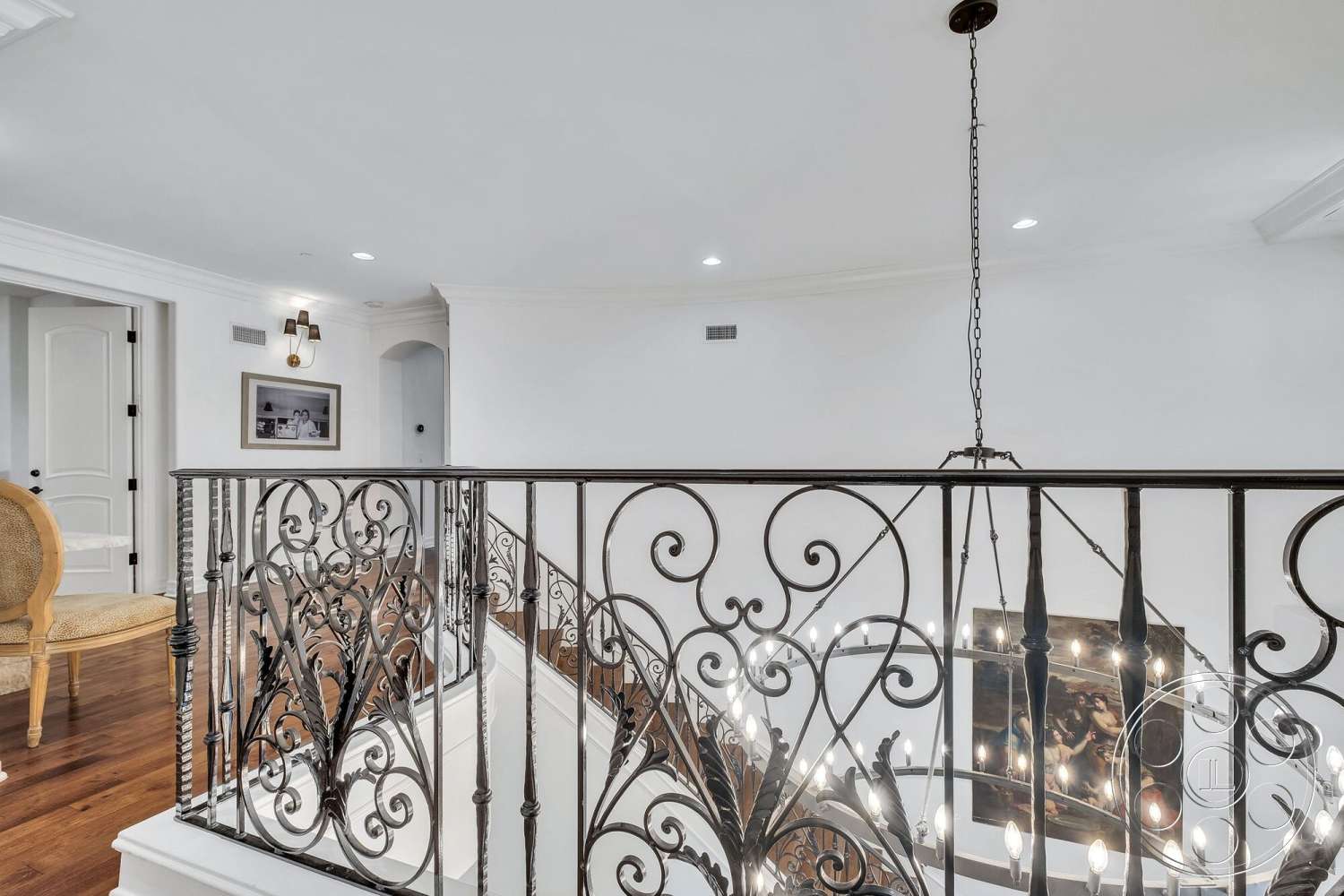 Medit 172 - natural light, recessed lighting, arched doorways, decorative chandelier, hardwood floors, wrought iron railing, upstairs landing, white painted walls, crown molding details