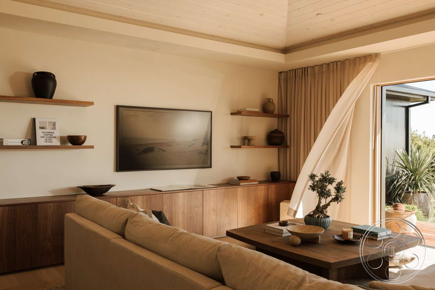 Modern 533 - natural light, floating shelves, textured accents, minimalist coffee table, living room setting, wood ceiling beams, walnut cabinetry, white painted walls, curtained doorway, luan floor panels, soft linen curtain