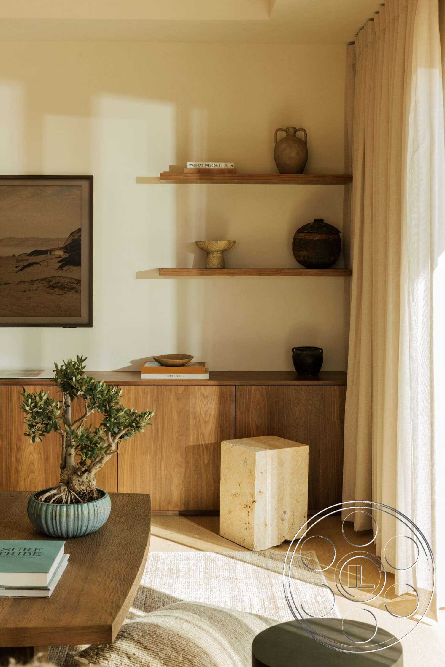 Modern 533 - minimalist decor, soft ambient lighting, walnut cabinetry, light oak flooring, rectangular area rug, natural wooden shelves, neutral textured wall finish, round ceramic planter, baldachin-style pottery, concrete accent stool, linen drapery