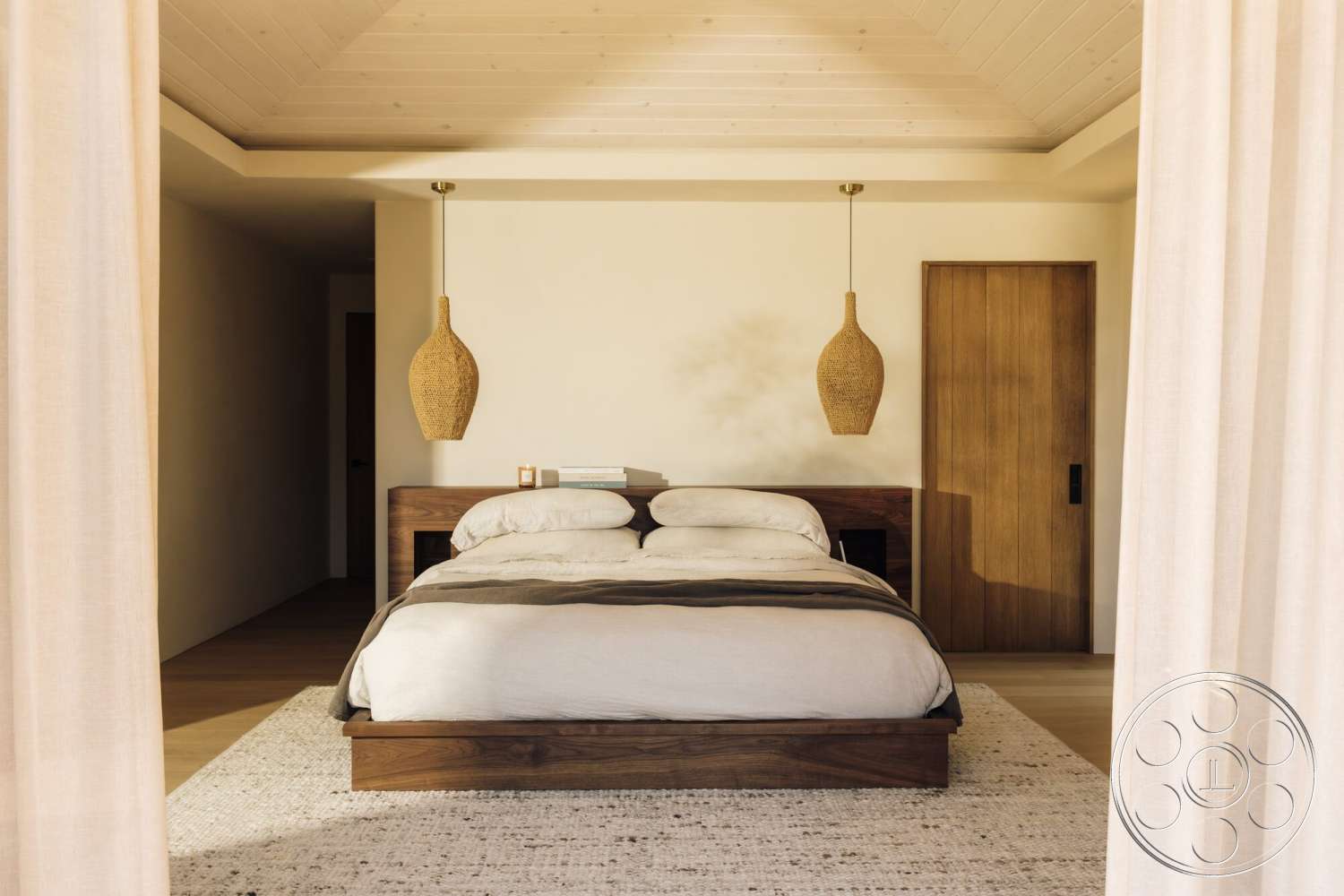 Modern 533 - textured area rug, wood panel ceiling, wooden door, woven pendant light, neutral painted walls, minimalist bedroom design, walnut bed frame, light-draped curtains