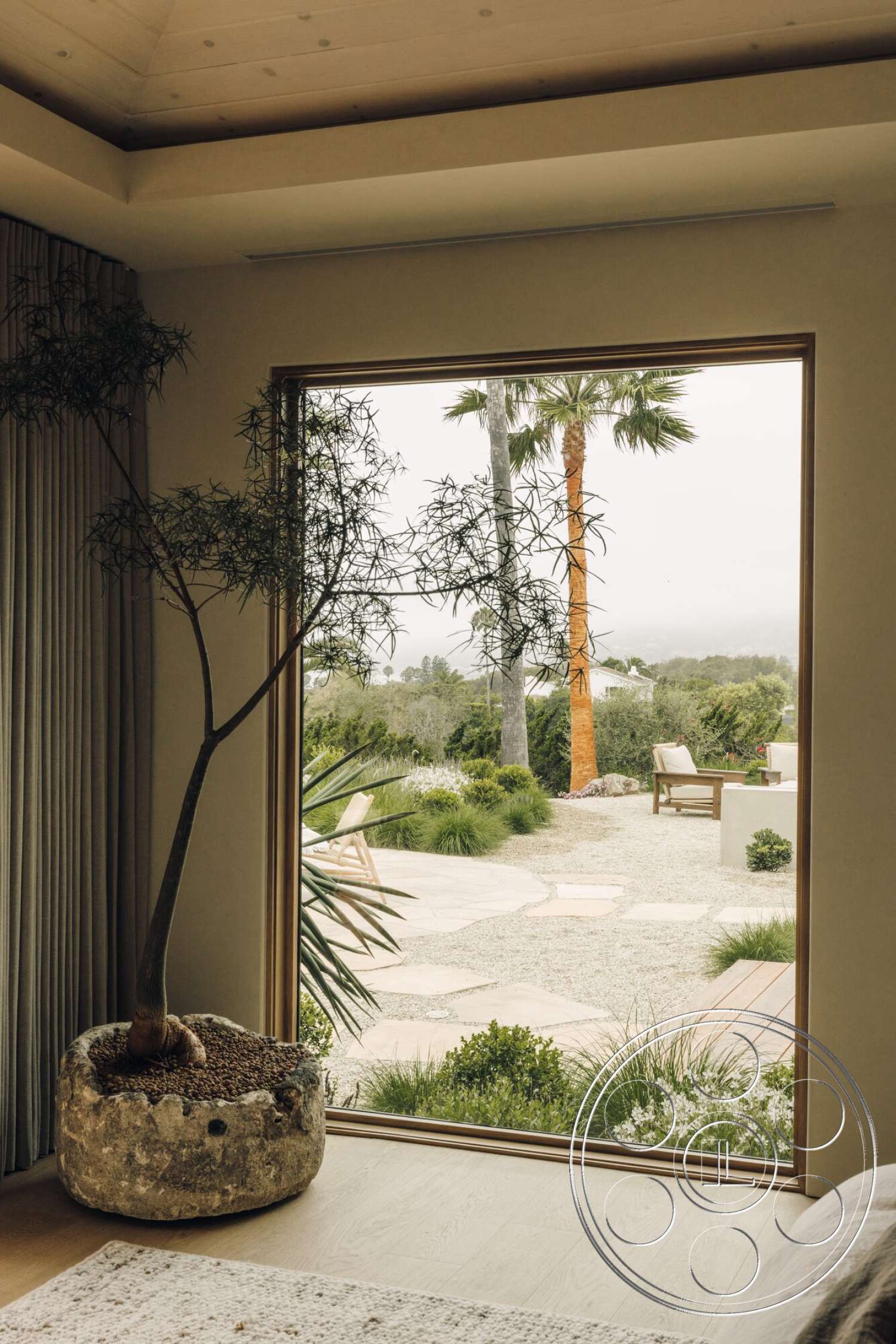 Modern 533 - hardwood flooring, landscaped garden view, floor-to-ceiling windows, textured plaster walls, tropical palm trees, wood beam ceiling, gravel patio flooring, rectangular outdoor seating area, rock planter