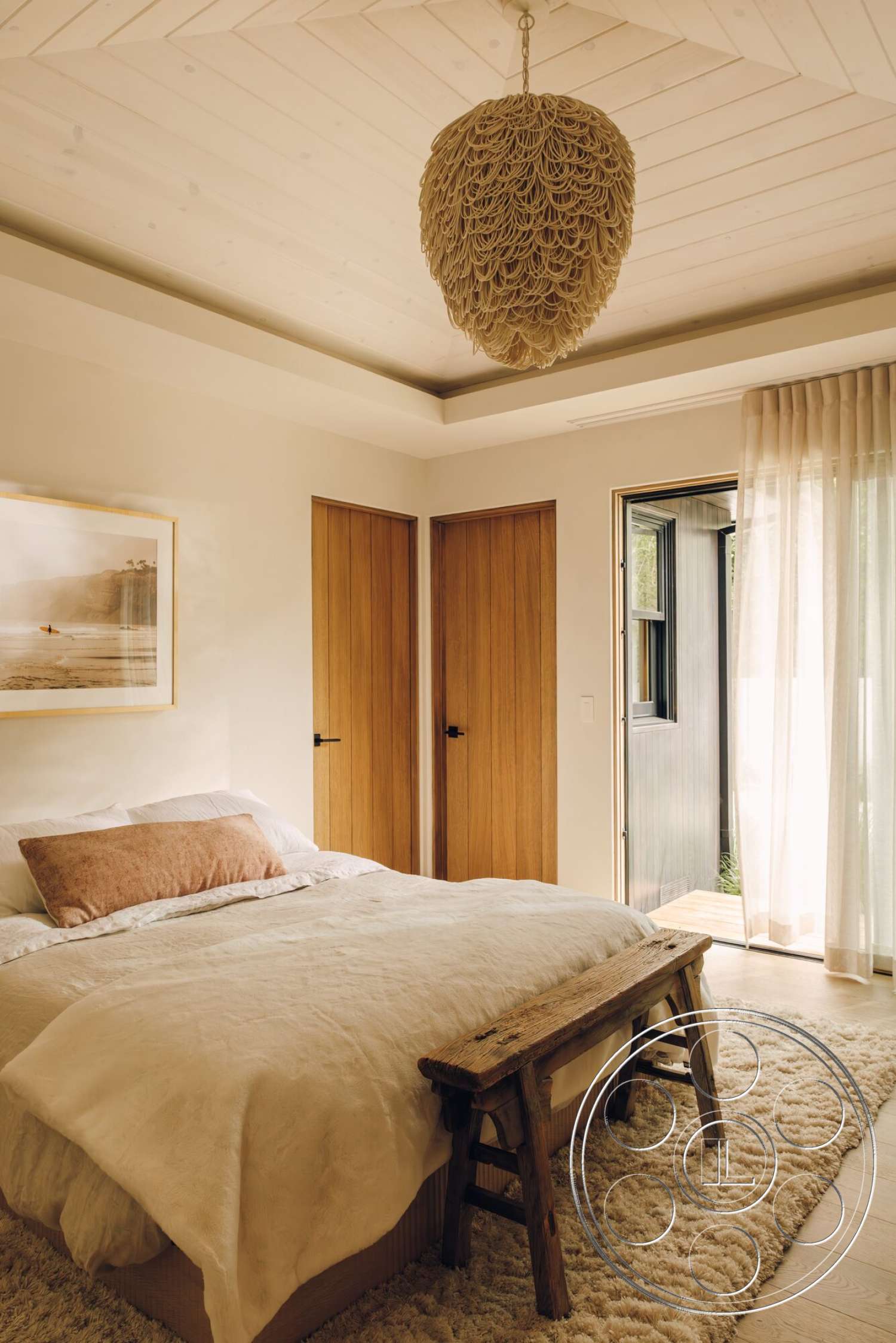 Modern 533 - minimalist decor, neutral color palette, linen bedding, floor-to-ceiling windows, wooden bed frame, queen-size bed, textured wood paneling, wood beam ceiling, light-filtering sheer curtains, rustic wooden bench, natural fiber pendant light, cream area rug, double interior doors, natural wood doors, artwork featuring beach scene