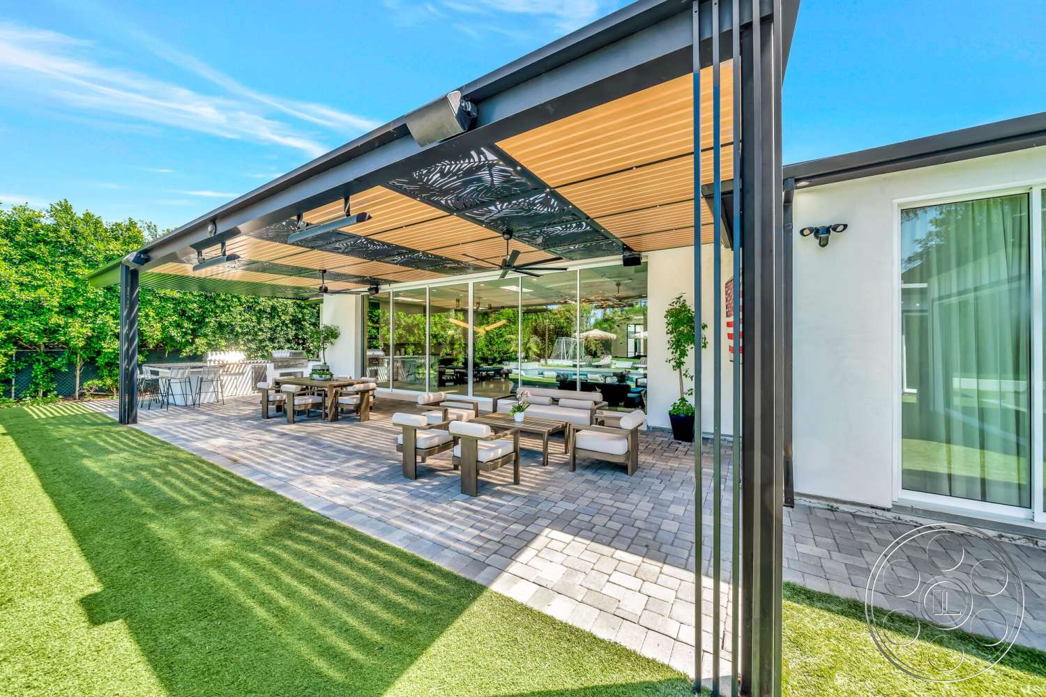 Modern 534 - contemporary outdoor furniture, artificial turf lawn, decorative wall paneling, modern outdoor lighting fixtures, exterior patio area, floor-to-ceiling glass walls, brick paver flooring, lush green foliage backdrop, metal pergola with wood slats