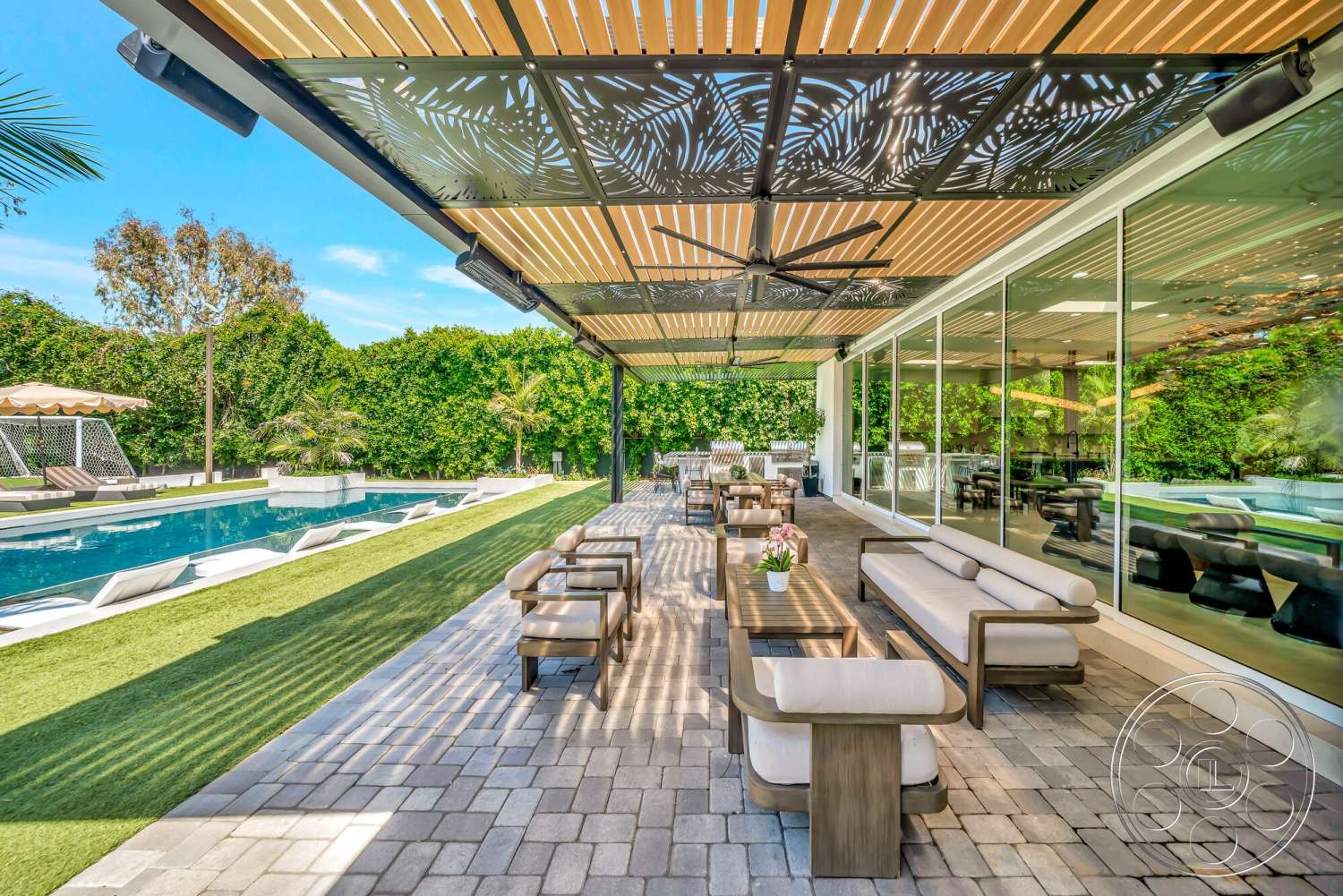 Modern 534 - glass sliding doors, ceiling fan, modern outdoor furniture, landscape greenery, rectangular pool, wood ceiling beams, stone planter, shaded outdoor seating area, paver patio flooring, concrete swimming pool