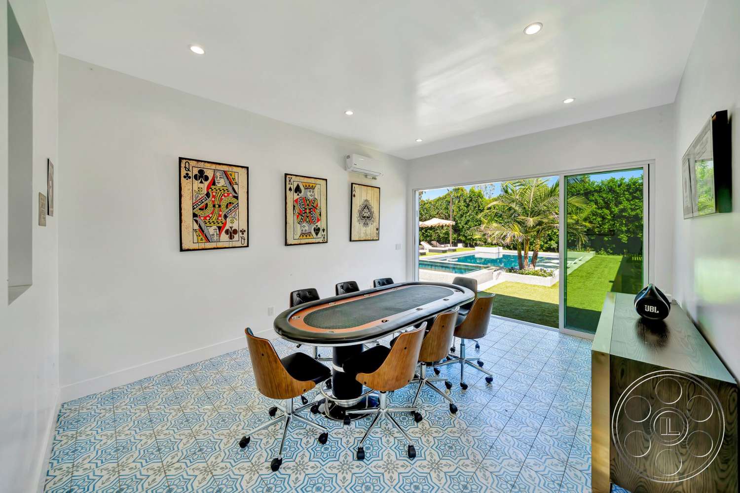 Modern 534 - natural light, tile flooring, palm trees, decorative wall art, landscaped backyard, white painted walls, floor-to-ceiling sliding glass doors, modern ceiling lights, exterior pool view, mid-century modern dining chairs, modern poker table, ornate patterned tile floors