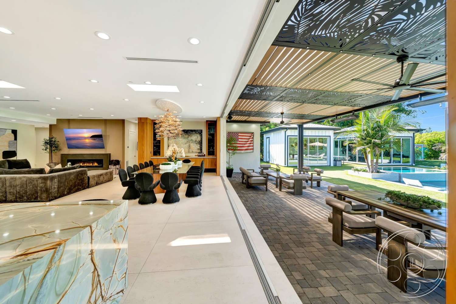 Modern 534 - exposed beam ceiling, concrete flooring, minimalist design elements, rectangular swimming pool, floor-to-ceiling windows, lush tropical landscaping, modern chandelier, linear fireplace, dark wood dining table, open floor plan layout, upholstered sectional sofa, paver patio flooring, natural stone kitchen island, textured ceiling paneling, built-in bar cabinets, outdoor patio seating area