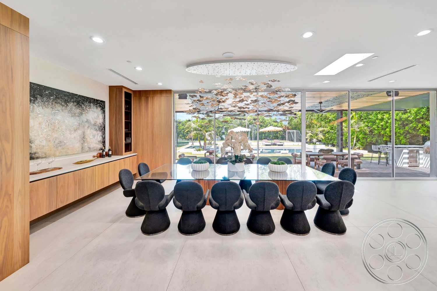 Modern 534 - minimalist design, open floor plan, wood cabinetry, abstract wall art, large glass windows, round dining table, seamless indoor-outdoor flow, contemporary aesthetic, black dining chairs, lush garden view, natural light ambiance, palm tree landscape, modern ceiling light fixture, white tile flooring, indoor dining area