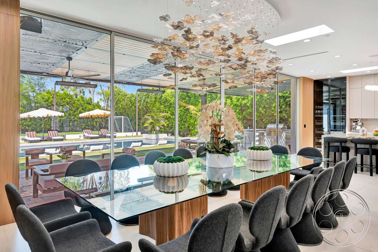Modern 534 - neutral color palette, contemporary style, open floor plan, glass dining table, landscaped backyard, courtyard view, modern kitchen design, concrete patio flooring, wood paneling accents, luxury dining area, decorative potted orchids, black upholstered dining chairs, stainless steel ceiling fixture, expansive glass walls