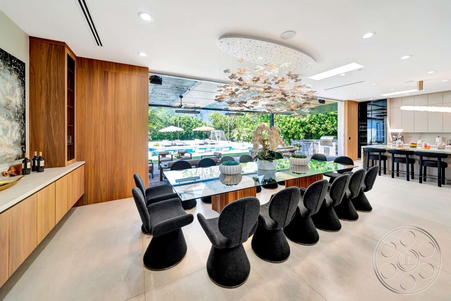 Modern 534 - high ceilings, neutral color palette, textured wall art, indoor plants, open floor plan, wood cabinetry, concrete flooring, upholstered dining chairs, floor-to-ceiling windows, glass dining table, linear ceiling lights, modern kitchen area, sculptural ceiling light fixture, visually connected outdoor patio, outdoor dining area visibility