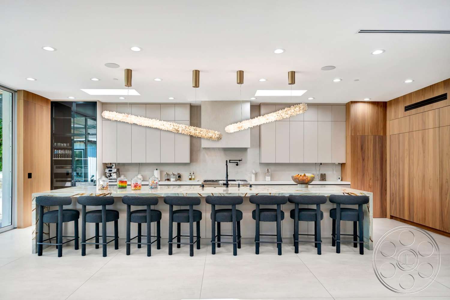 Modern 534 - minimalist design, stainless steel appliances, wood cabinetry, recessed ceiling lights, pendant lighting fixtures, multicolored accent decor, open concept kitchen, marble kitchen island, smooth countertop surface, glass-front cabinetry, concrete kitchen flooring, flat-panel kitchen cabinets, bar seating with upholstered stools
