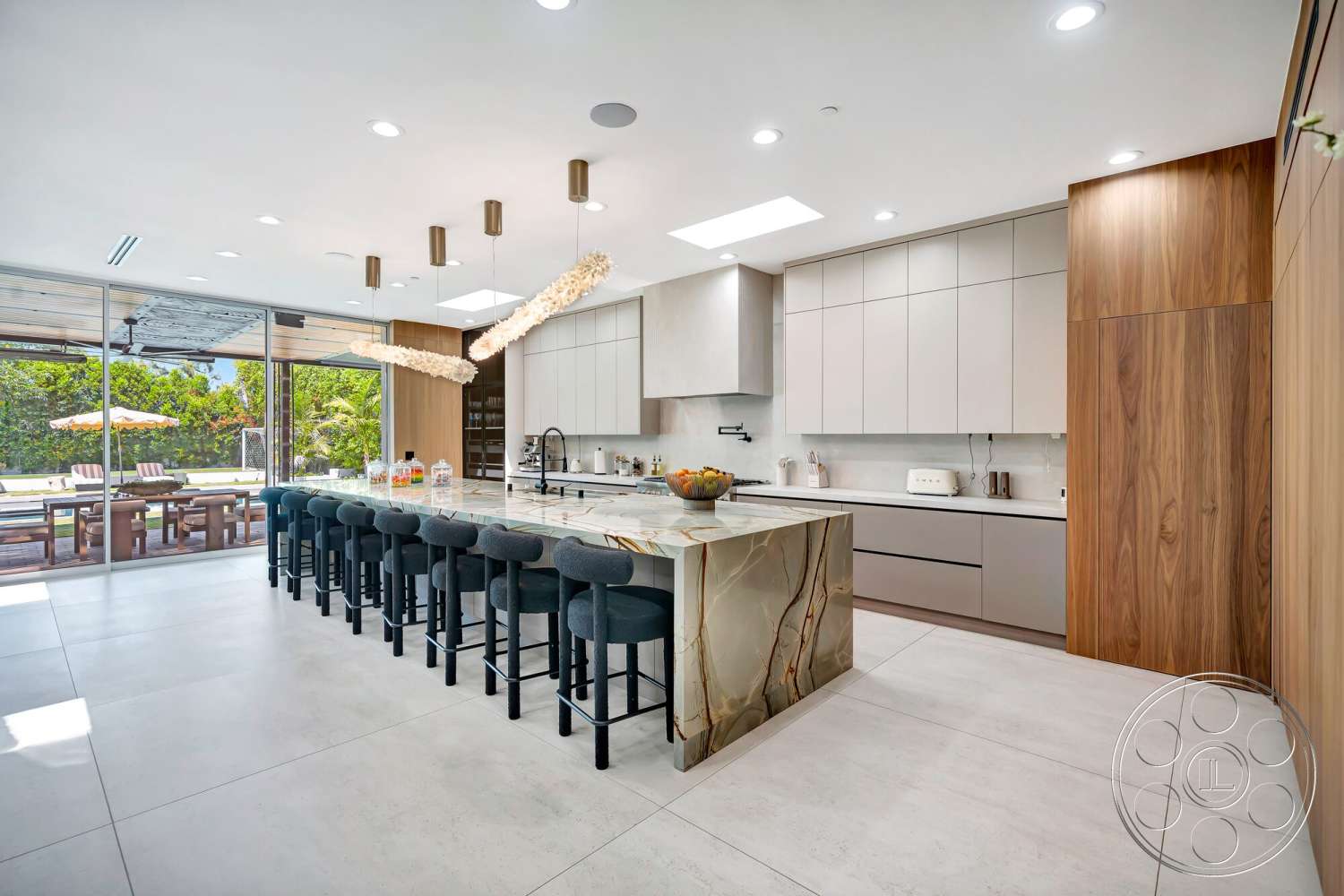 Modern 534 - natural light, minimalist design, stainless steel appliances, concrete flooring, modern lighting fixtures, hanging pendant lights, sleek countertop, horizontal wood paneling, high-gloss cabinetry, open layout kitchen, marble kitchen island, floor-to-ceiling glass doors, outdoor dining area view, wood veneer cabinets, comfortable barstools