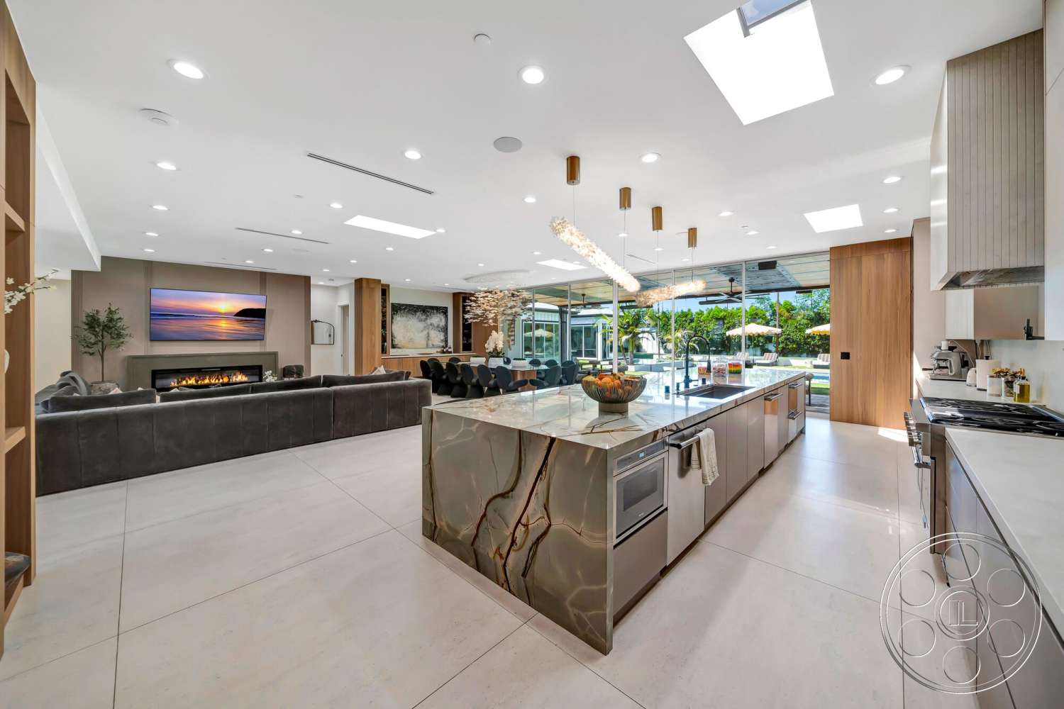 Modern 534 - neutral color palette, open floor plan, stainless steel appliances, exposed beam ceiling, concrete flooring, modern pendant lighting, floor-to-ceiling windows, dining area with modern chairs, textured wall treatment, built-in cabinetry, large sliding glass doors, pendant light fixtures, fireplace feature wall, panoramic garden view, vessel sink, metal kitchen island with veined stone countertop, living area with sectional sofa