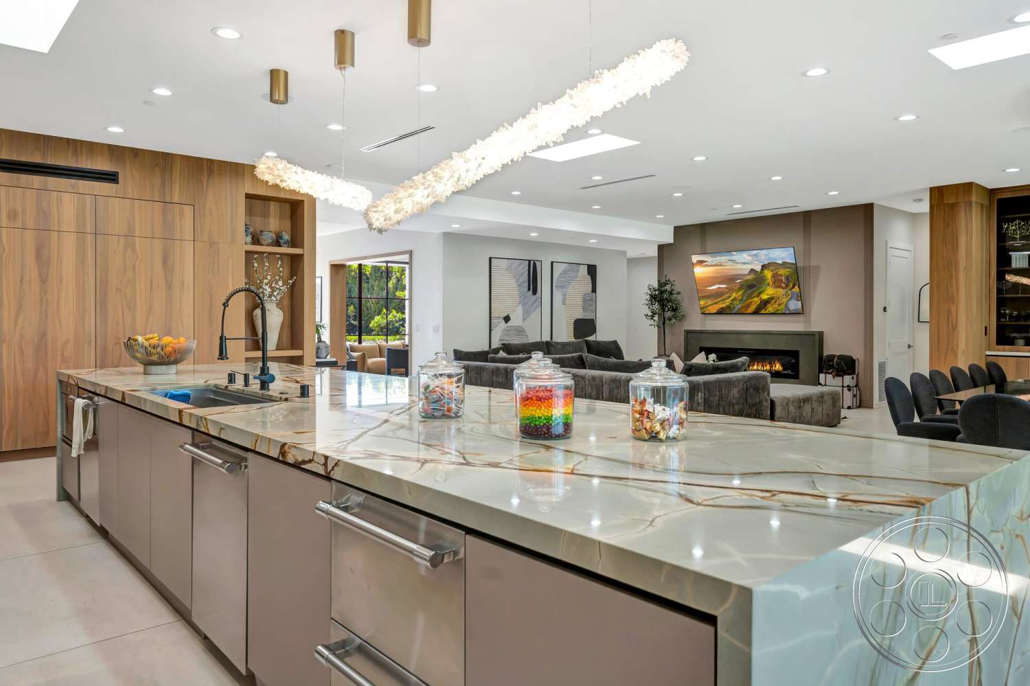 Modern 534 - neutral color palette, wall-mounted television, wood cabinetry, ceramic tile flooring, floor-to-ceiling windows, exposed ceiling, modern fireplace, pendant lighting fixtures, stainless steel kitchen appliances, open-concept living area, quartz kitchen countertops, living room lounge area, texture contrast between wood and stone