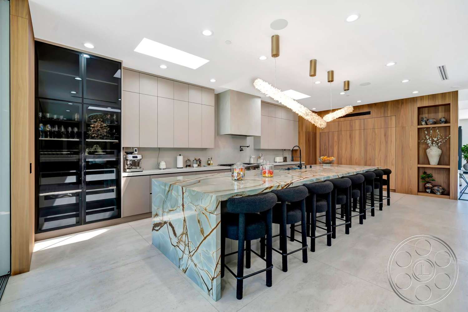 Modern 534 - minimalist design, modern pendant lighting, bar seating area, light wood cabinetry, stainless steel sink, white plaster walls, open concept kitchen, quartz kitchen countertops, skylight ceiling, concrete kitchen flooring, black glass refrigerator, walnut accent wall
