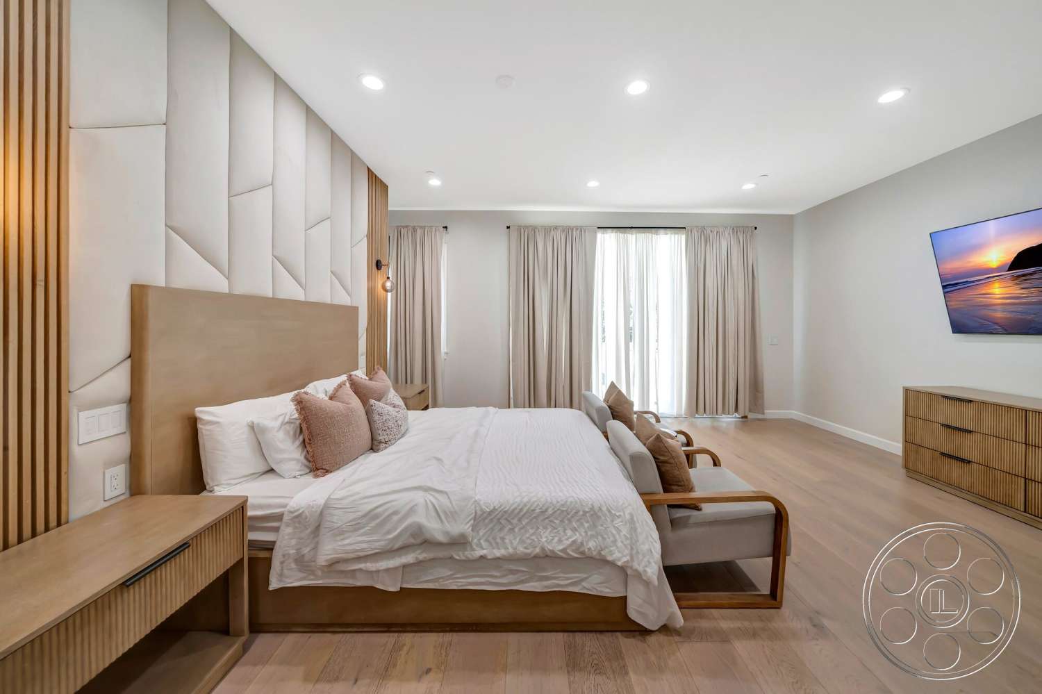 Modern 534 - light wood flooring, contemporary design elements, curtained windows, natural light flooding in, minimalist wall-mounted TV, textured fabric bed linens, upholstered headboard wall, plaid accent pillows, modern wood nightstand