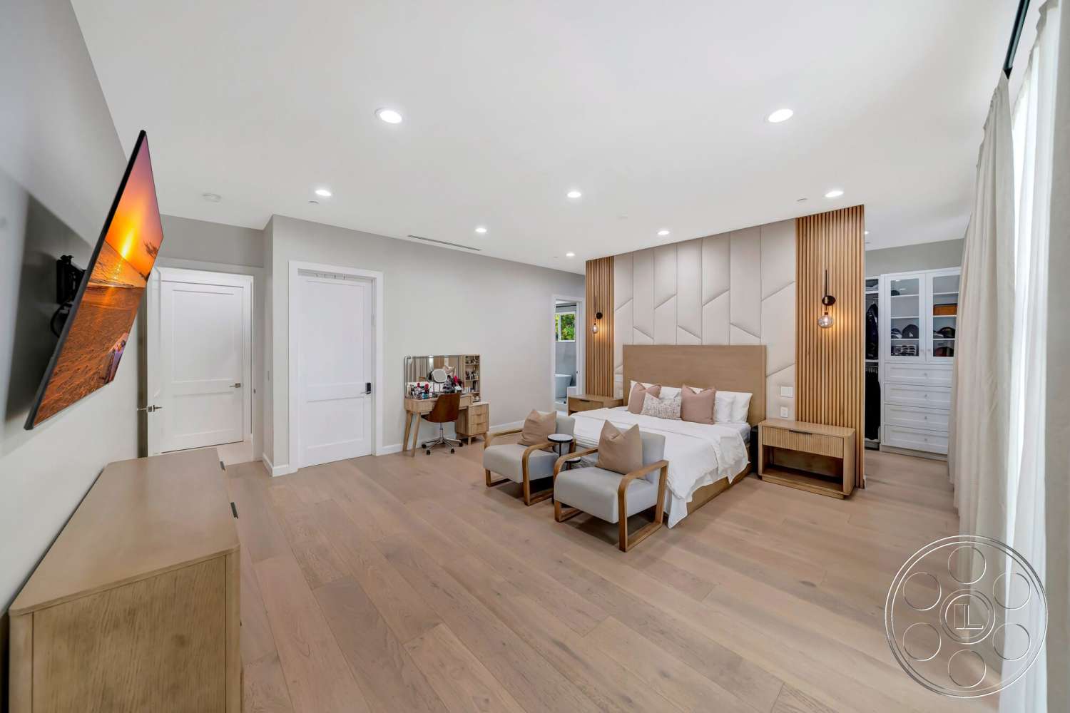 Modern 534 - neutral color palette, textured wall treatment, stylish bedside tables, plush seating area, recessed ceiling lights, minimalist interior design, hardwood bedroom floors, exterior window view, accent lighting fixtures, glass closet doors, wall-mounted flat screen TV, modern queen-sized bed, living area workspace