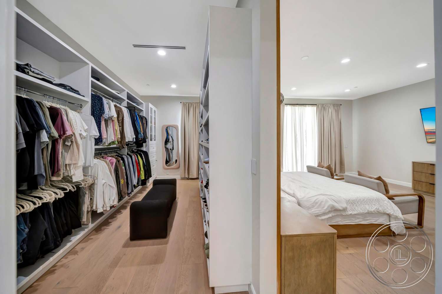Modern 534 - floor-to-ceiling windows, full-length mirror, minimalist furniture style, hardwood bedroom floors, built-in storage cabinets, white painted walls, open closet design, plush home seating, light-colored drapery, modern bedroom layout