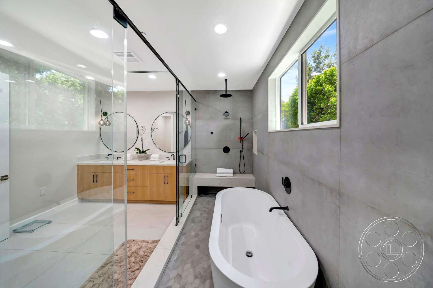 Modern 534 - minimalist design, freestanding bathtub, glass shower enclosure, round mirrors, modern pendant lighting, chrome bathroom fixtures, concrete bathroom walls, wood vanity cabinets, white marble bathroom flooring, hexagon tile accent flooring