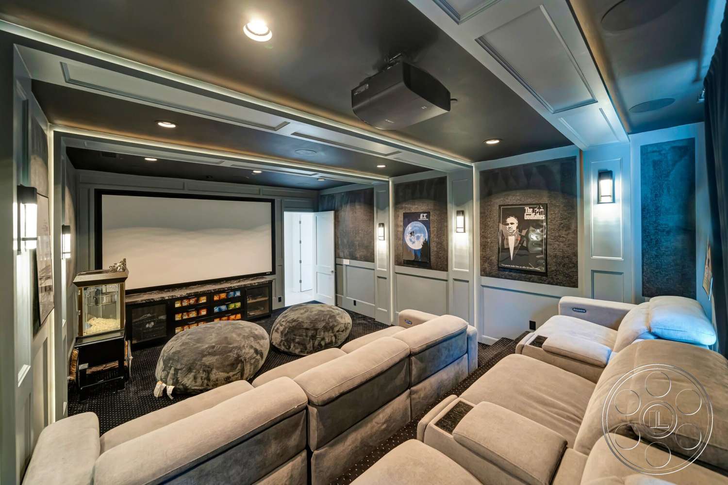 Modern 534 - recessed lighting, carpeted flooring, projector screen, upholstered sectional sofa, panelled walls, home theater room, tray ceiling design, dark gray wall treatments, built-in media cabinet, accent wall artwork, popcorn machine feature