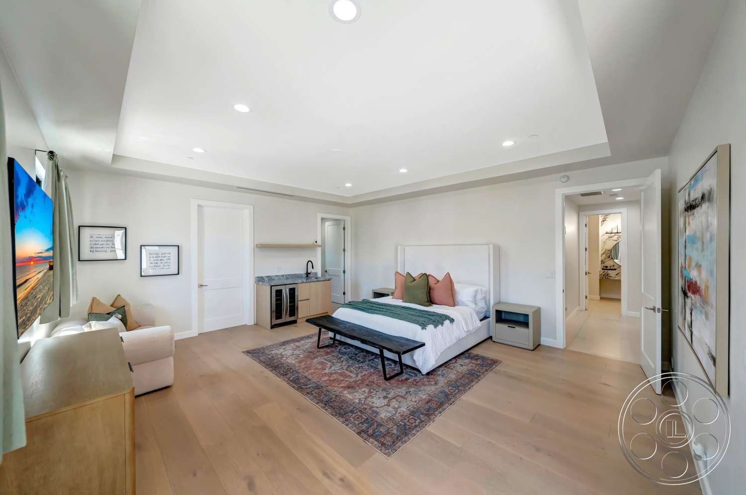 Modern 534 - recessed lighting, textured area rug, vaulted ceiling, king-sized bed, arched doorways, soft window treatments, luxurious bedding, hardwood bedroom floors, white painted walls, modern bedside table, decorative artwork on walls, king-sized bed with upholstered headboard, breakfast bar seating, mounted flat-screen TV, glass door to bathroom area, grey kitchen cabinetry, granite countertop of kitchenette, accent pillows in earthy tones