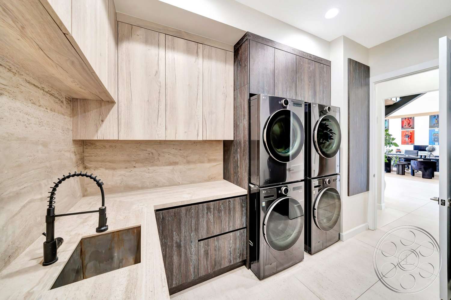 Modern 534 - neutral color palette, wood cabinetry, laundry room, minimalist design elements, textured plaster walls, light tile flooring, black faucet with pull-down sprayer, concrete countertop sink, modern cabinetry design, stacked washer and dryer unit, open doorway into adjacent room
