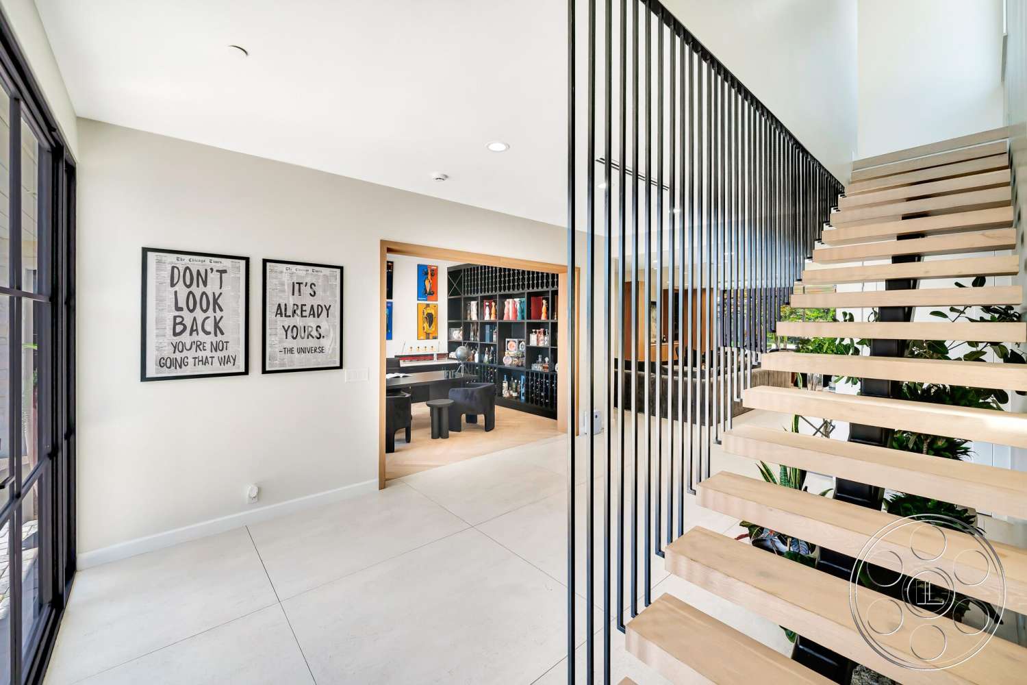 Modern 534 - concrete flooring, open staircase, modern architectural style, wooden shelving unit, spacious hallway, steel stair railings, floating stairs, textured white walls, natural light source, exposed wood treads, wall art decor