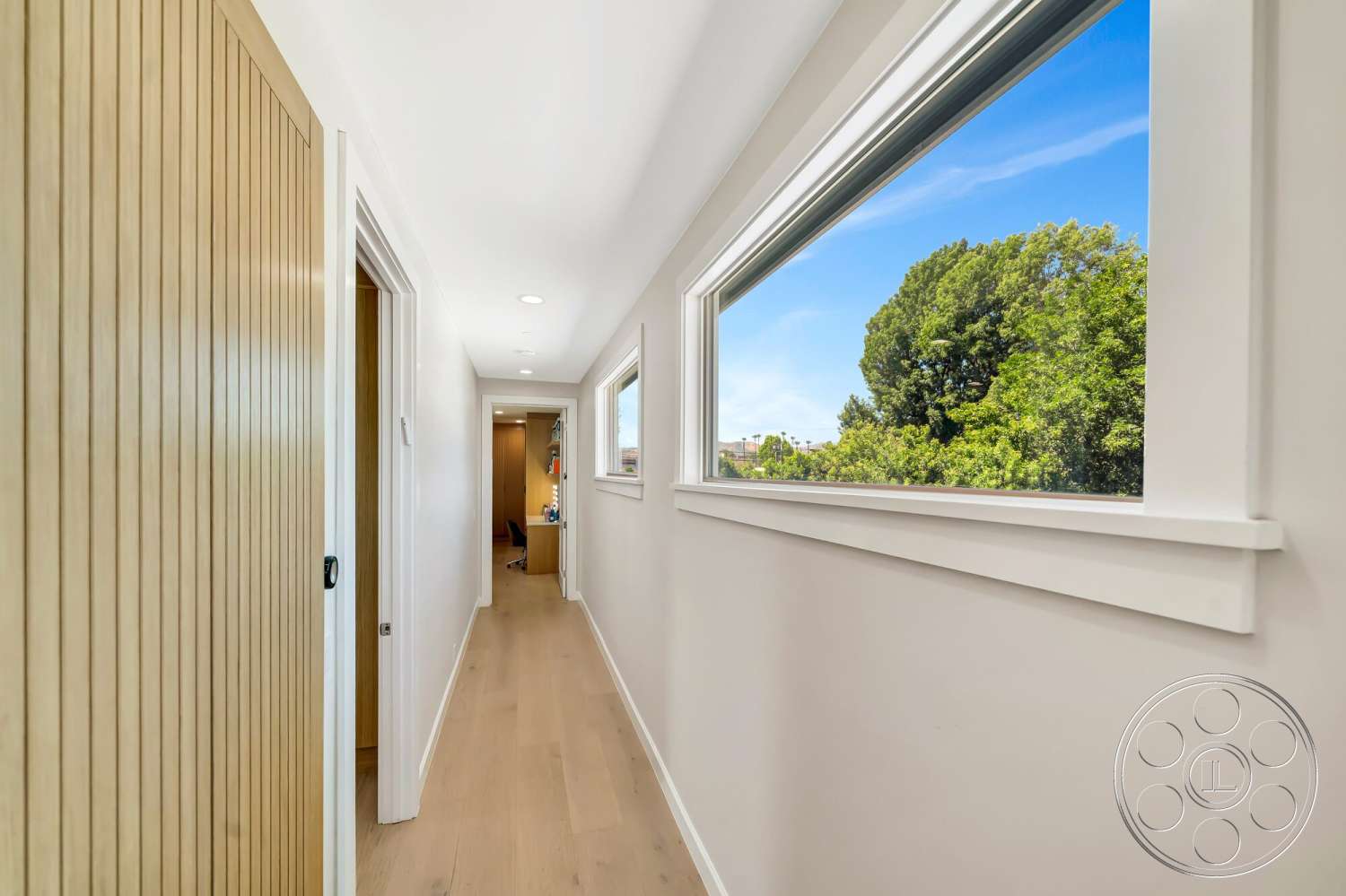 Modern 534 - neutral color palette, large windows, natural light, minimalist design, flat ceiling, modern trim details, interior hallway, white painted walls, light wood plank flooring, shiplap wall treatment, paned window views
