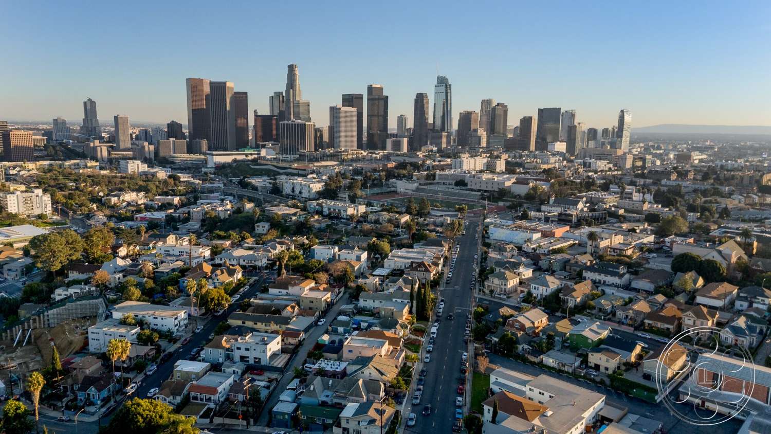 Craftsman 65 - exterior, residential neighborhood, single-family homes, suburban setting, urban landscape, city skyline view, asphalt road, varied architectural styles, flat roofs, modern high-rise buildings, tree-lined streets