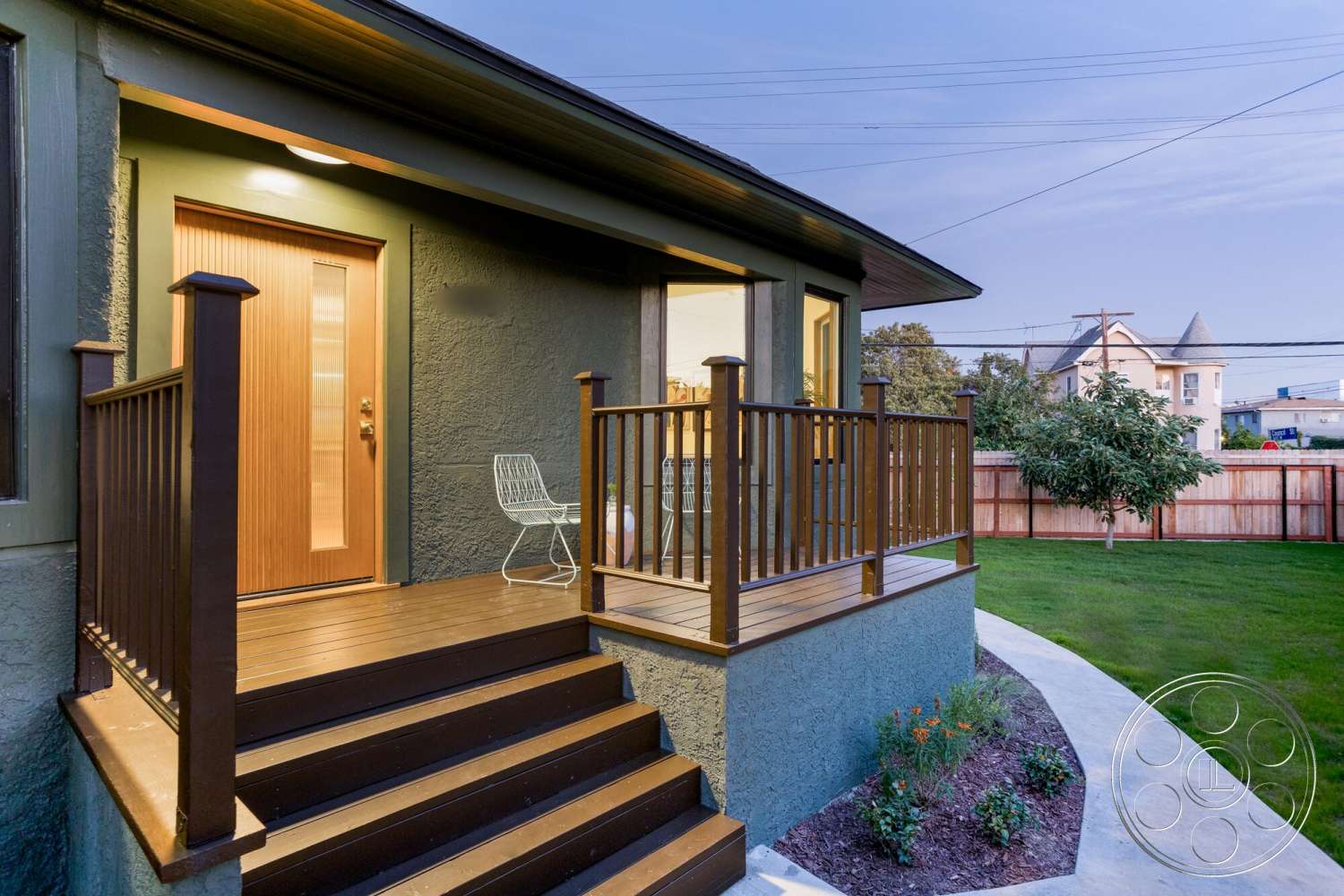 Craftsman 65 - exterior, outdoor seating area, green lawn, landscaped garden area, sidewalk pathway, modern bungalow style, wooden deck stairs, textured stucco wall, glass front door, brown wooden railing