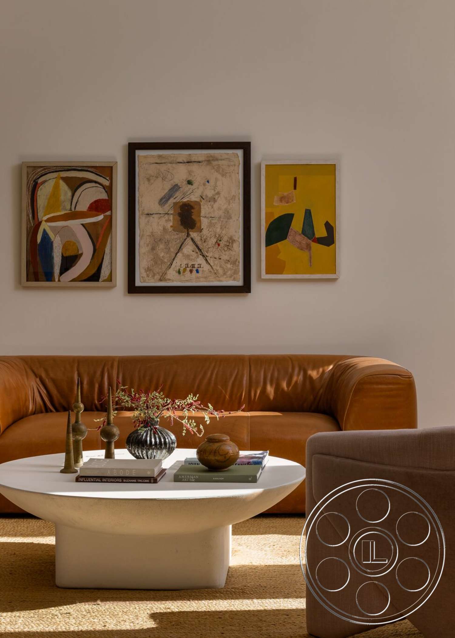 Craftsman 65 - neutral wall colors, decorative vases, modern design elements, leather couch, woven jute area rug, framed abstract wall art, hardcover coffee table books, white circular coffee table