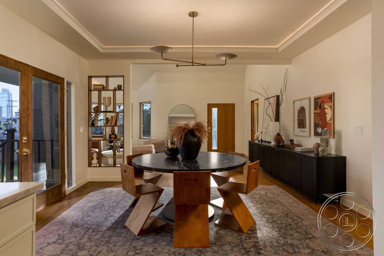 Craftsman 65 - contemporary style, textured area rug, open floor plan, painted white walls, natural light from windows, round marble dining table, glass sliding door, built-in shelving unit, modern ceiling light fixture, hardwood floor dining area, wooden dining chairs with geometric design, decorative vases and artwork, minimalist sideboard