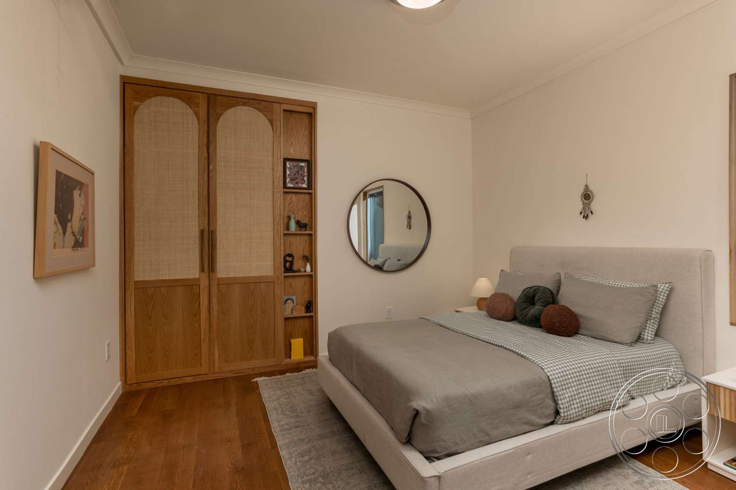 Craftsman 65 - framed wall art, decorative throw pillows, contemporary bedside lamp, hardwood bedroom floors, white painted walls, round wall mirror, built-in wooden shelving unit, light gray upholstered bed, wooden sliding doors with rattan inserts