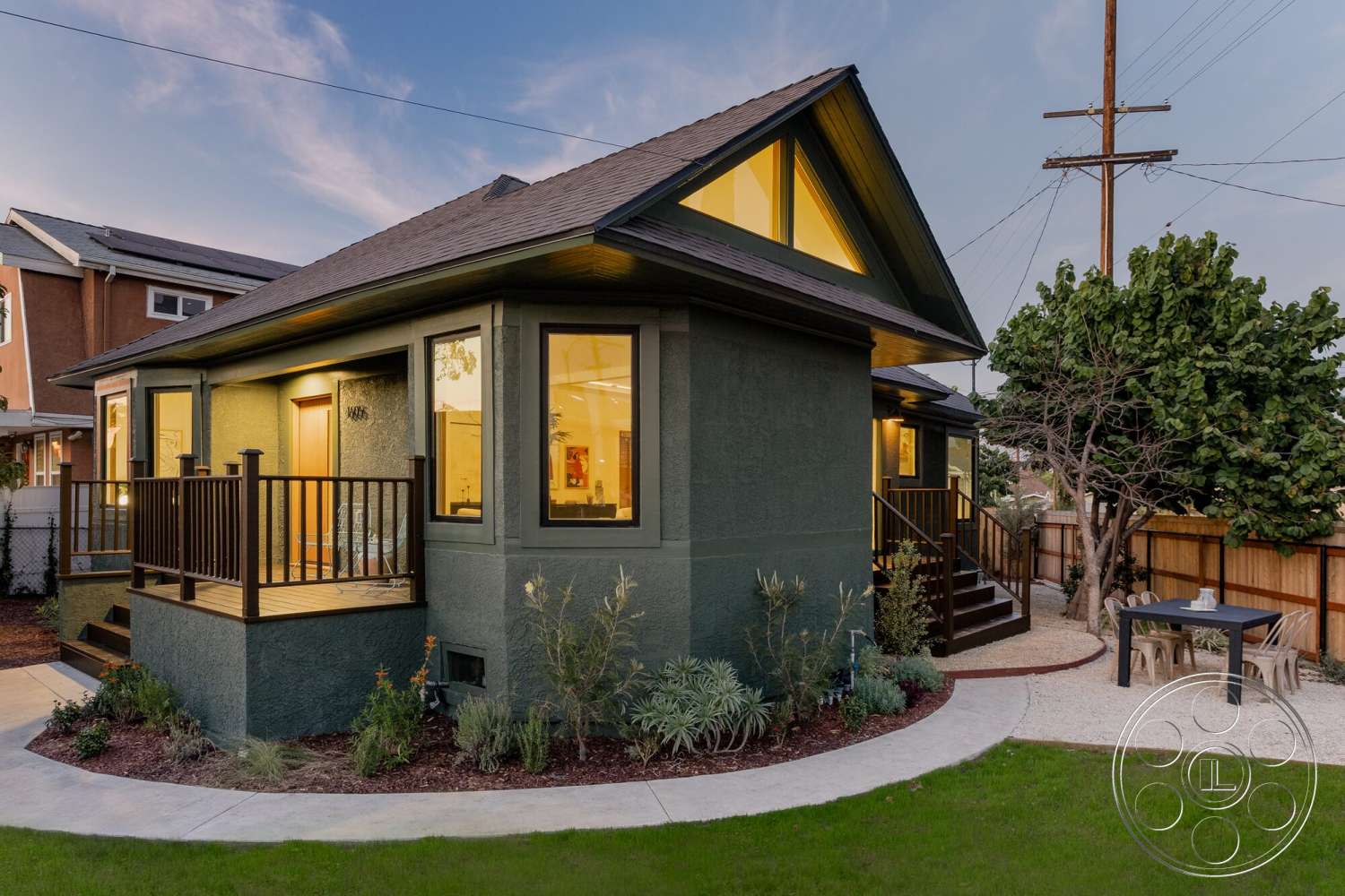 Craftsman 65 - exterior, landscaped garden, asphalt shingle roof, outdoor seating area, green lawn, gabled roof, stucco walls, circular pathway, modern farmhouse style, paned windows, gravel patio, dark brown wood railing, rectangle porch, flat backyard