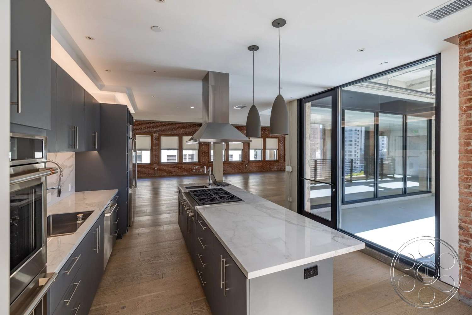 Loft 1 - neutral color palette, hardwood flooring, stainless steel appliances, open concept living space, pendant lighting fixtures, modern kitchen design, marble kitchen countertop, exposed brick accent wall, floor-to-ceiling glass doors, industrial style architecture