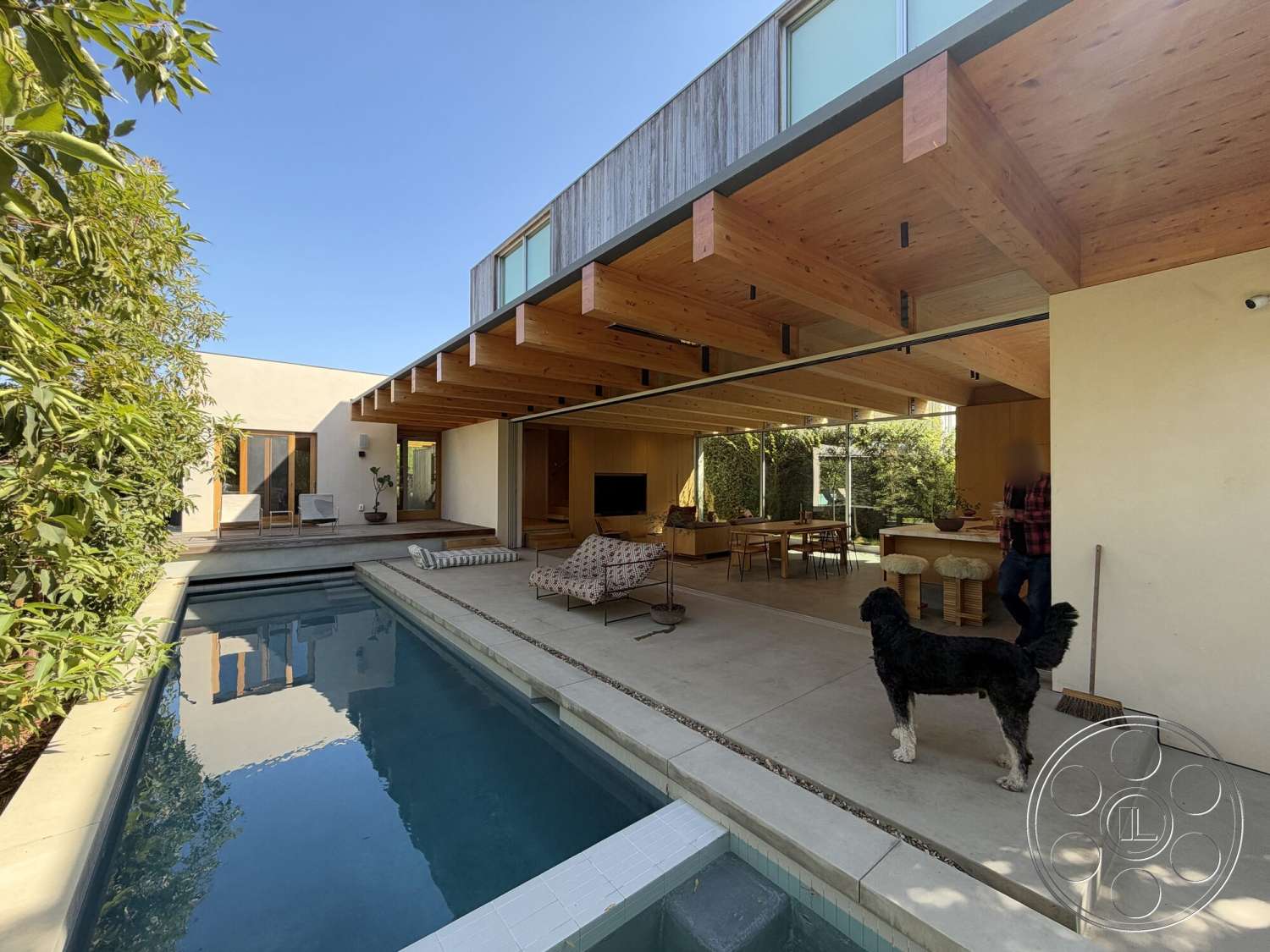Retro House - natural light, exterior, minimalist design, glass sliding doors, floor-to-ceiling windows, rectangular pool, modern residential architecture, landscaped garden area, concrete patio flooring, wood beam ceiling, concrete pool border, exposed wood paneling, hardwood dining table
