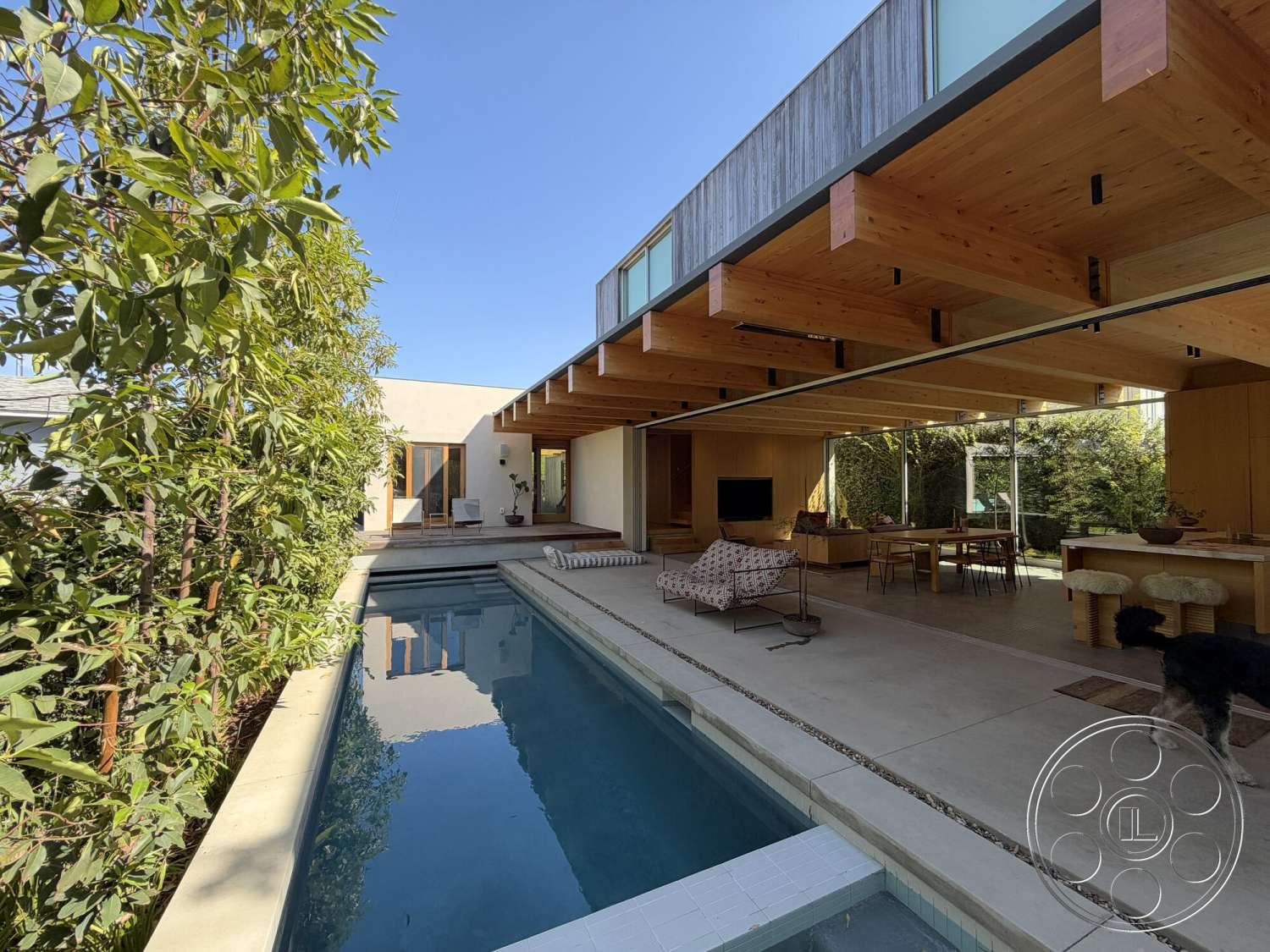 Retro House - exterior, landscaped garden, sliding glass doors, modern architectural style, wood deck, wood accent wall, rectangular pool, exposed wood ceiling beams, floor-to-ceiling glass windows, concrete pool border, concrete patio floor, open floor plan living area, sunlit outdoor living space, efficiency landscaping