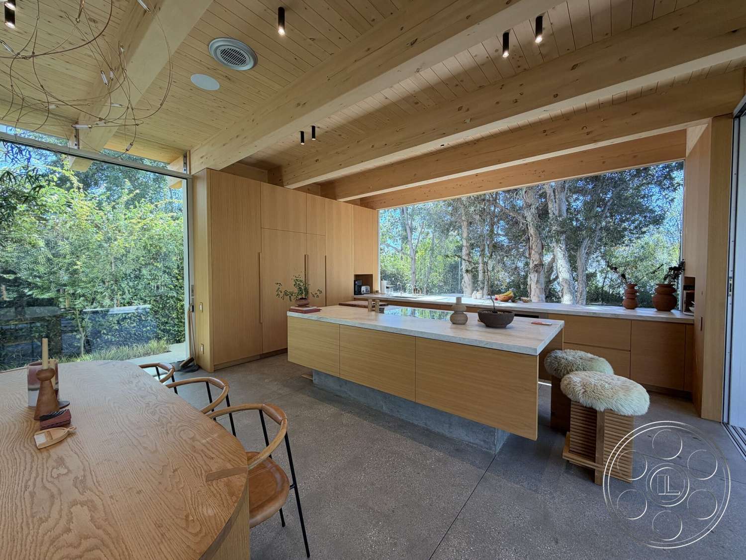 Retro House - minimalist decor, natural light, concrete flooring, floor-to-ceiling windows, marble countertop, light wood paneling, modern dining table, exposed wood ceiling beams, open kitchen layout, curved dining chairs, concrete kitchen island base, vegetation view