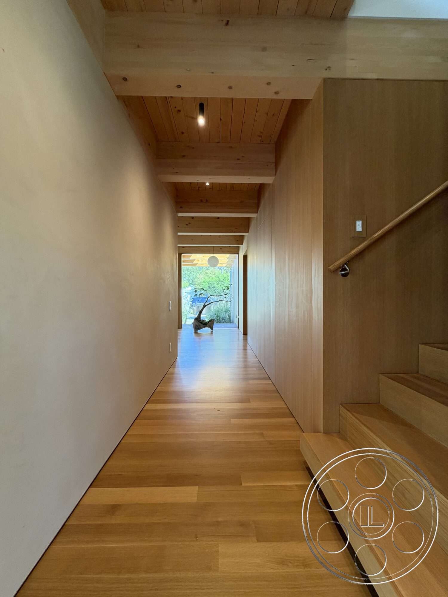 Retro House - hardwood flooring, minimalist design, open space layout, textured plaster walls, natural light from windows, staircase with wooden steps, exposed wood ceiling beams, interior hallway
