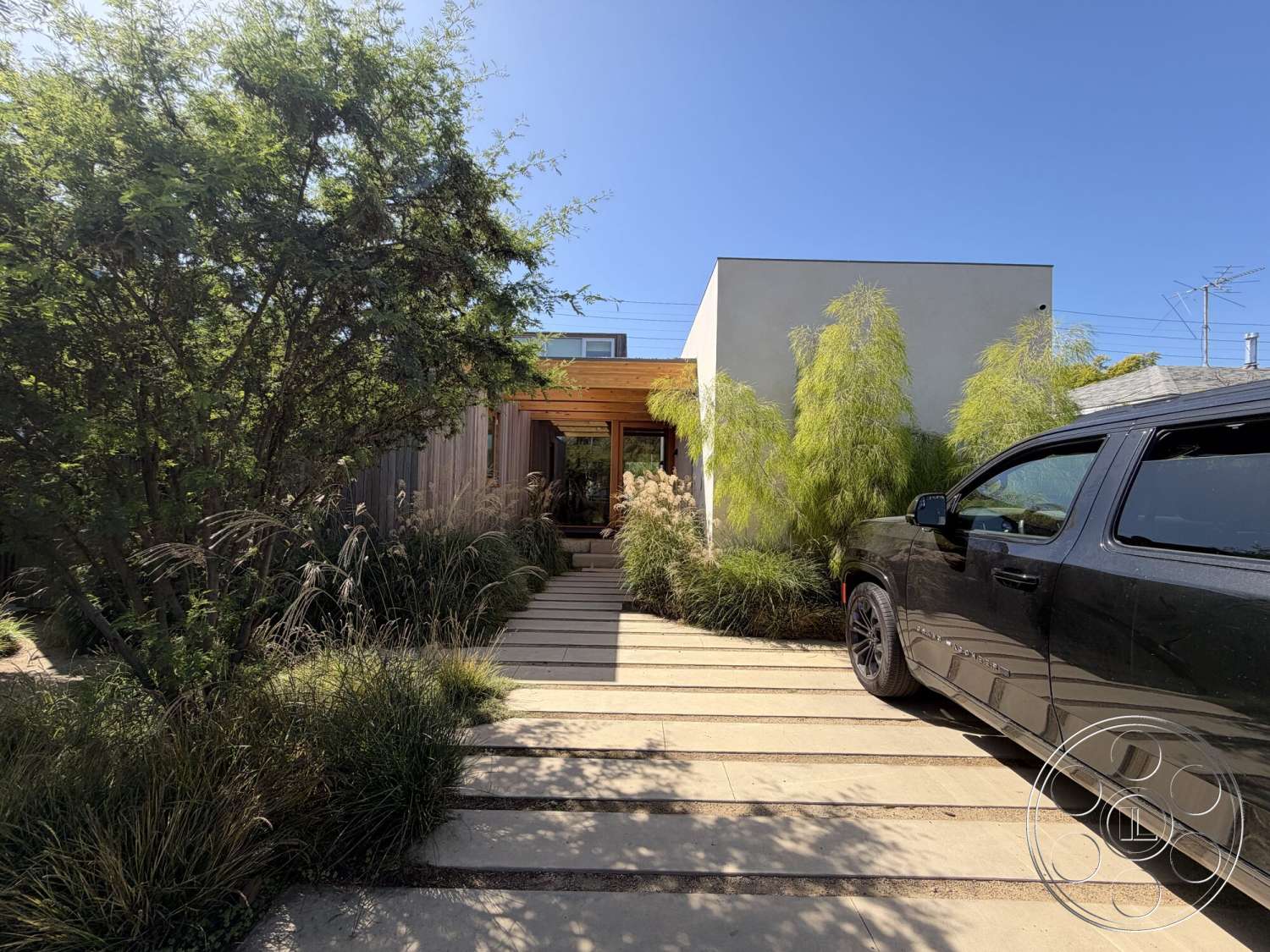 Retro House - flat roof, minimalist design, concrete pathway, modern residential architecture, landscape grasses, exterior wall cladding, wooden entry canopy, black truck, outdoor planting beds, interior entrance view