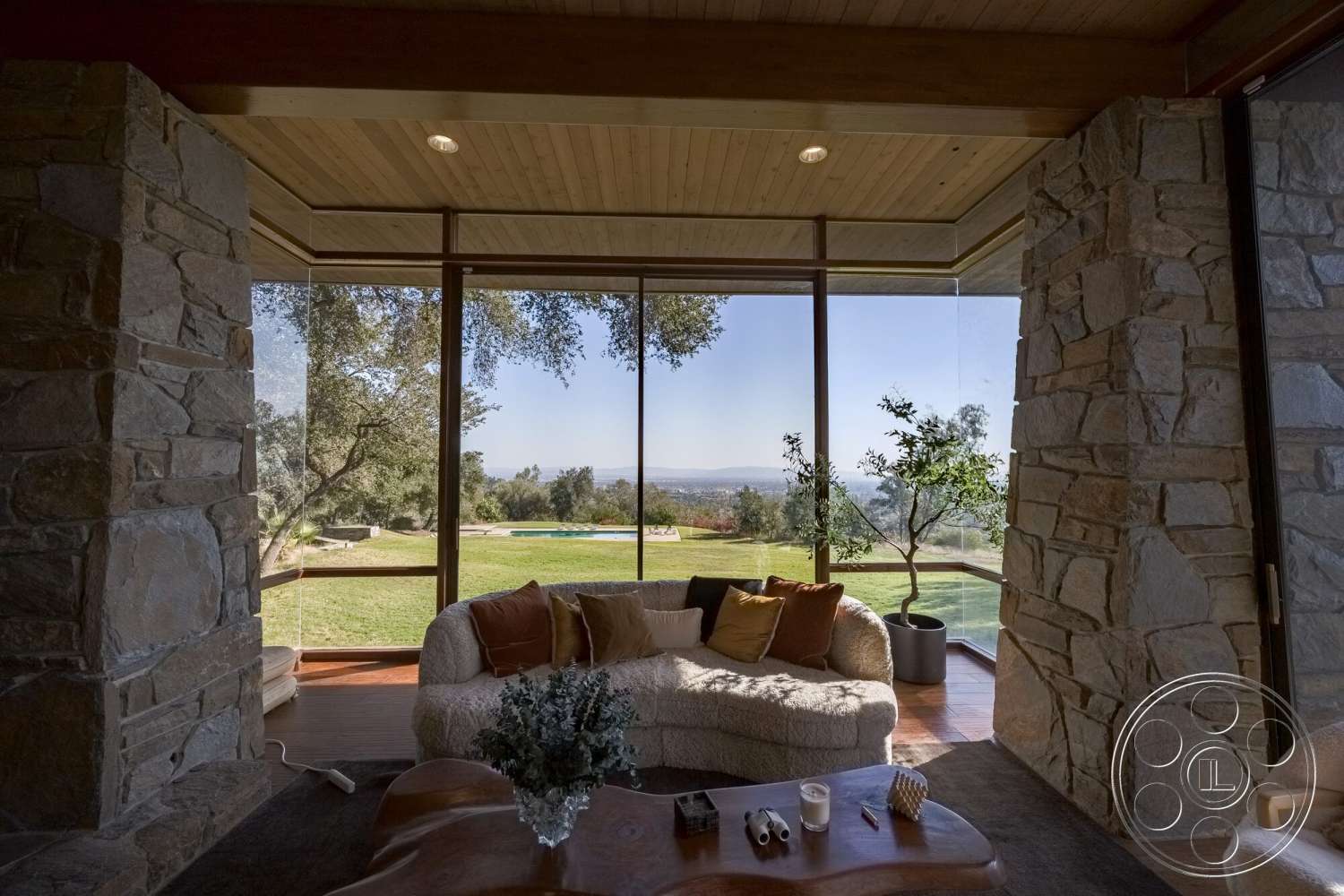 MCM 29 - exterior, landscape view, floor-to-ceiling windows, wood ceiling panels, hardwood floor, open living room, contemporary architectural style, glass partition walls, stone feature walls, natural light design