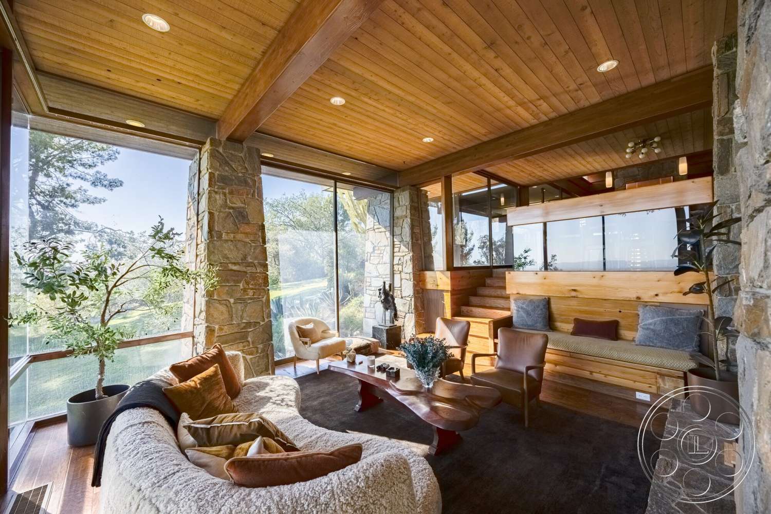 MCM 29 - hardwood flooring, modern furniture, cozy seating area, large glass windows, open living space, sustainable design elements, wood panel wall, exposed wood ceiling beams, interior living room, natural light interior, garden view setting, contemporary architectural details, stone accent walls, sunny indoor location