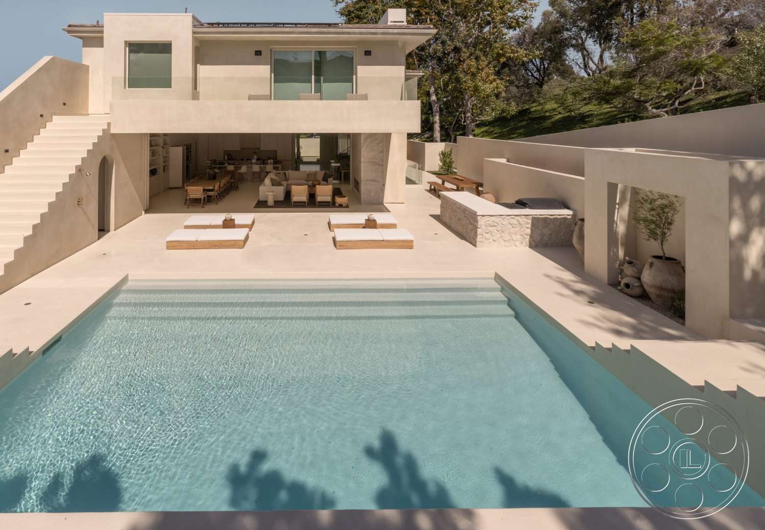 Modern 535 - exterior, minimalist design, open floor plan, glass sliding doors, landscaped greenery, concrete patio, outdoor dining area, stone barbecue area, modern architectural style, wooden bench seating, sun loungers, rectangular pool, stucco wall finish, exposed aggregate concrete, built-in outdoor seating, concrete swimming pool, upward-sloping landscape