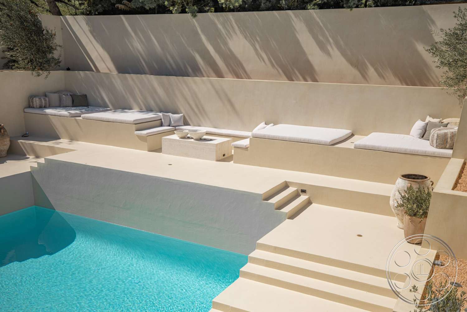 Modern 535 - exterior, concrete steps, outdoor lounging area, concrete pool deck, rectangular pool, decorative stone planters, minimalist outdoor design, plastered wall surfaces, wooden lounge cushions, natural landscape elements, sunlit poolside ambiance