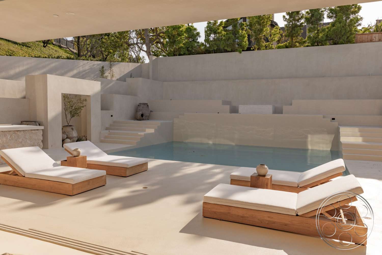 Modern 535 - exterior, outdoor space, minimalist design, landscaped greenery, sunlit area, rectangular pool, open-air setting, concrete patio flooring, textured stone feature wall, light-colored concrete walls, concrete pool steps, wood lounge chairs