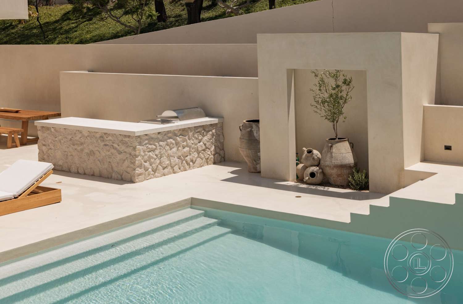 Modern 535 - exterior, landscaped garden view, textured plaster walls, concrete pool deck, modern lounge chair, ceramic decorative pots, minimalist outdoor setting, wooden patio dining table, stone water feature wall, concrete outdoor steps