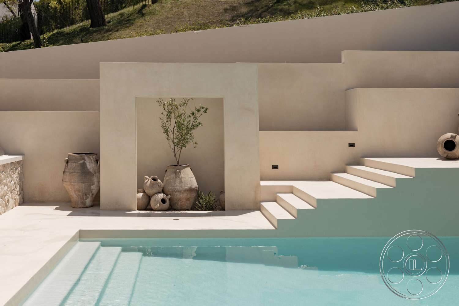 Modern 535 - exterior, rectangular swimming pool, landscaped hillside, outdoor relaxation area, earth-tone color palette, natural stone wall elements, concrete pool steps, smooth stucco walls, terracotta pottery planters, minimalist poolside design, subtle water reflection