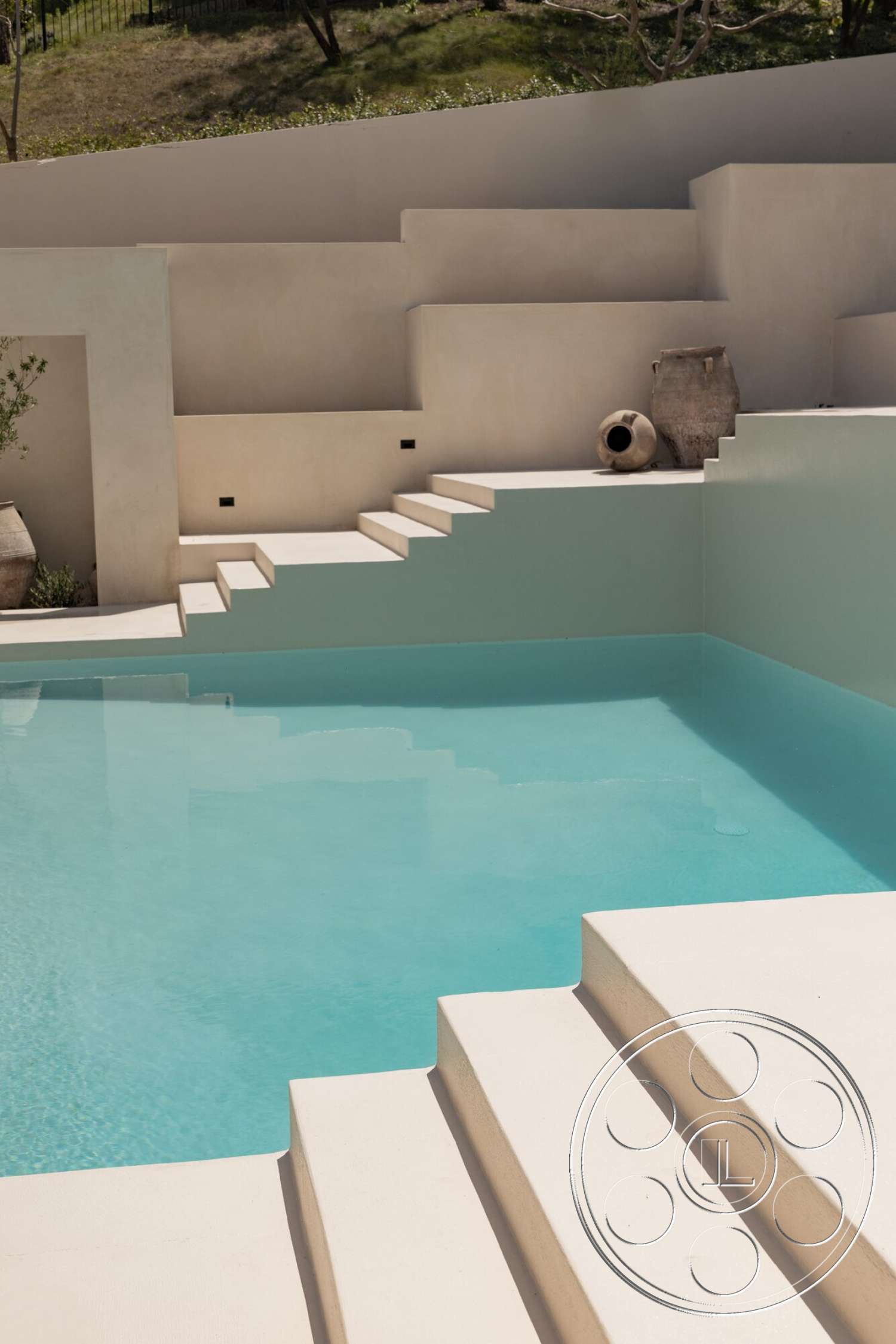 Modern 535 - exterior, minimalist design, landscaped hillside, plastered walls, rectangular pool, stone planter, natural light exposure, concrete pool steps, smooth surface textures, softly curved pool edges