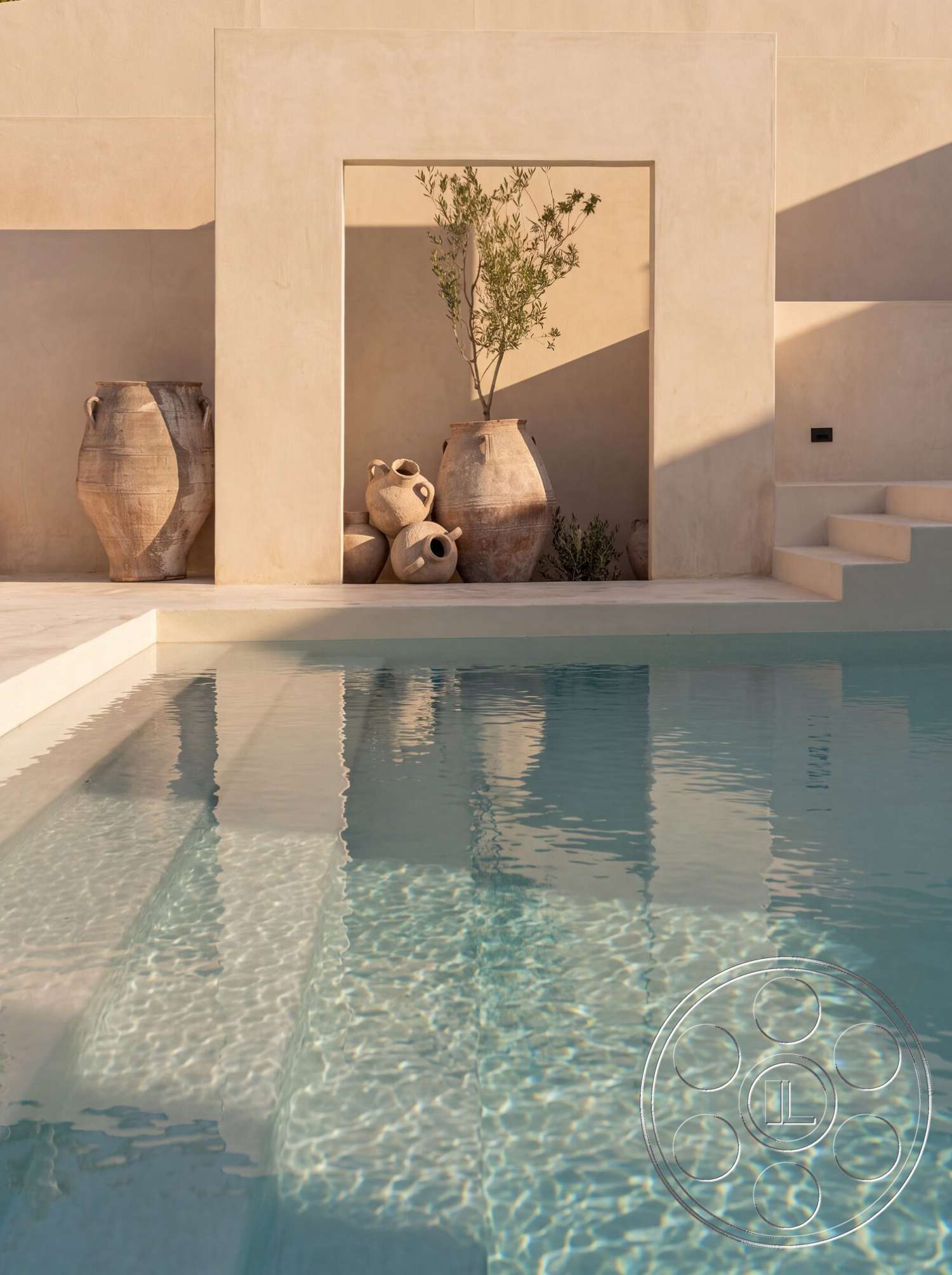 Modern 535 - minimalist design elements, rectangular swimming pool, interior pool area, light-colored plaster walls, textured concrete pool steps, terra cotta pottery planters, greenary accent, natural light reflections on water surface